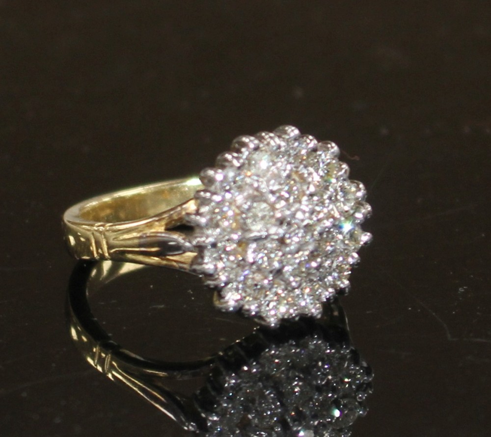 A modern 18ct gold and diamond cluster ring, size M, gross weight 7.8 grams.